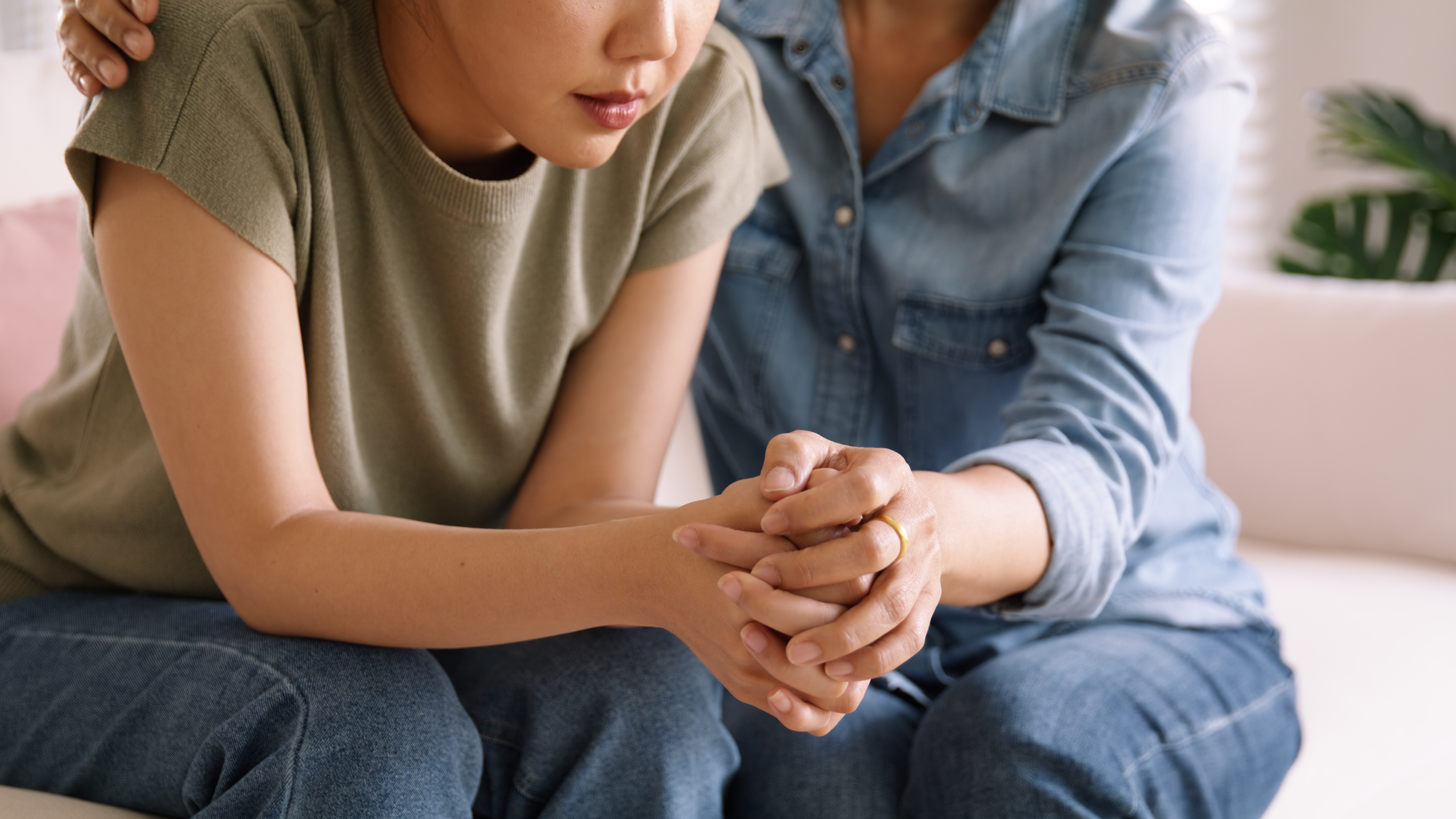 a woman comforting another woman