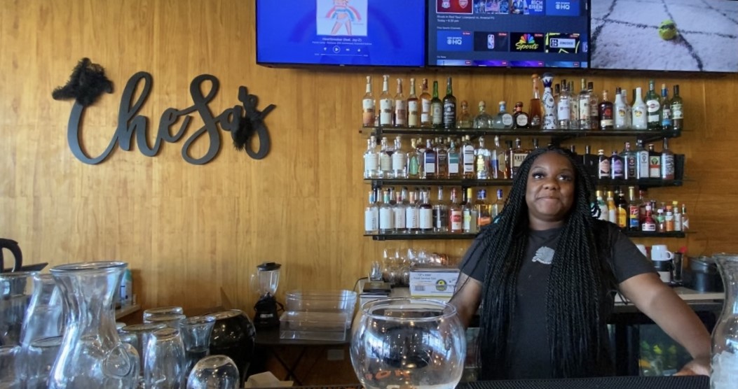 CheSa standing behind the bar at her business: CheSa’s Bistro and Bar in Chicago, Illinois