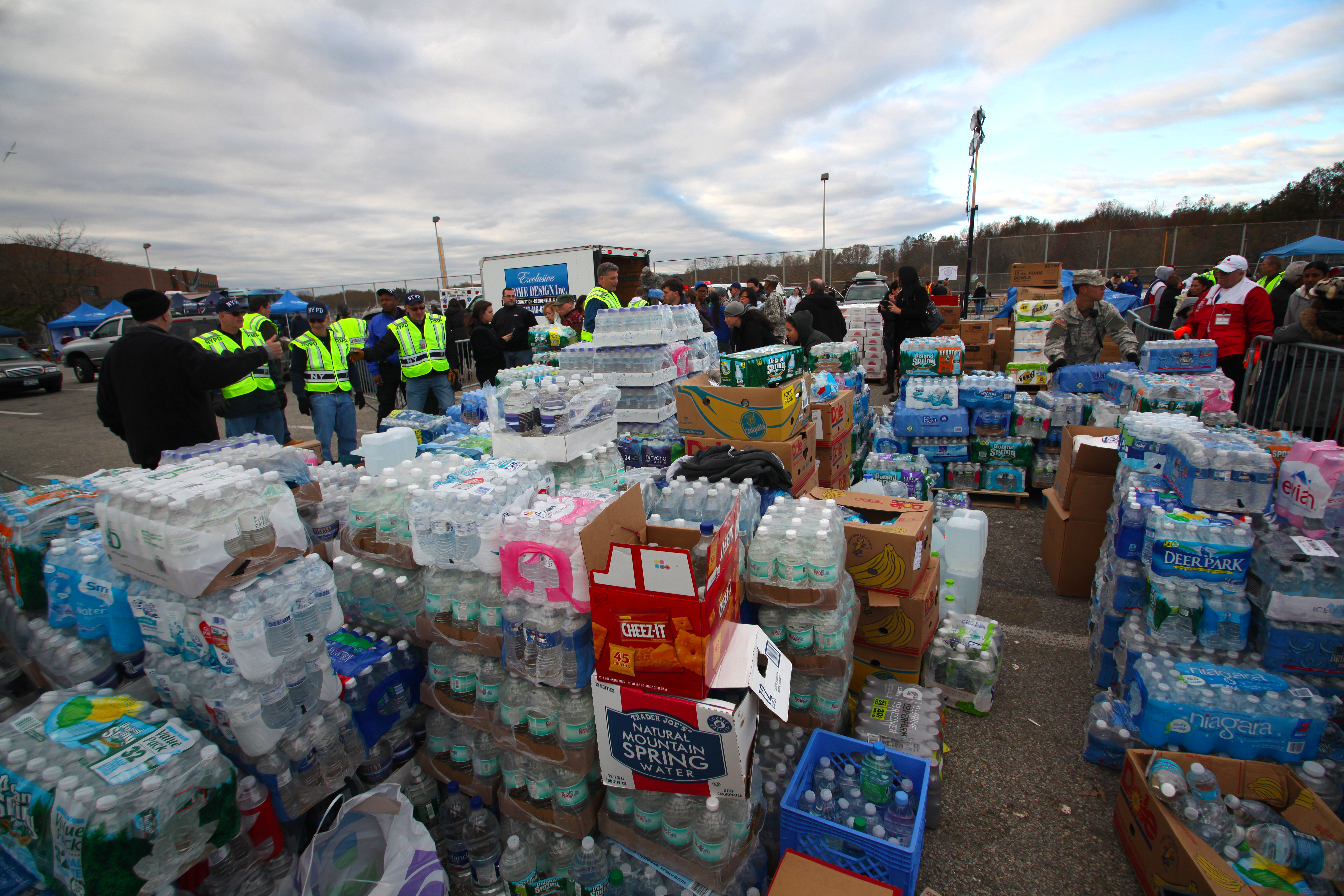 National guard & Red Cross brought tons of supplies to aid hurricane victims. Piles of bottled water stacked for distribution